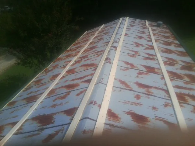 Rusted metal roof panels with new wood purlins before replacement — Storm Damage Roof Repair in Ravenel by Roofing Brothers