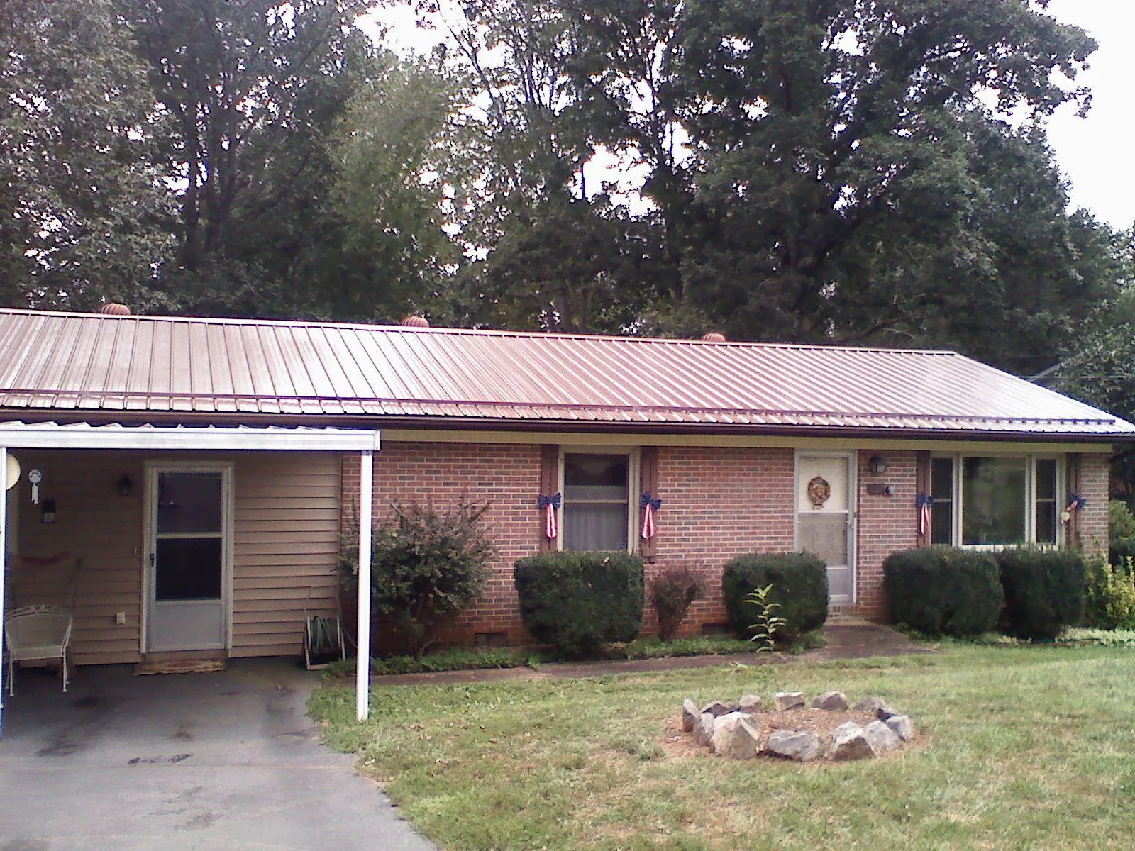 Bronze metal roof and carport on a brick ranch home — Roof Repair work by our crew in Ravenel