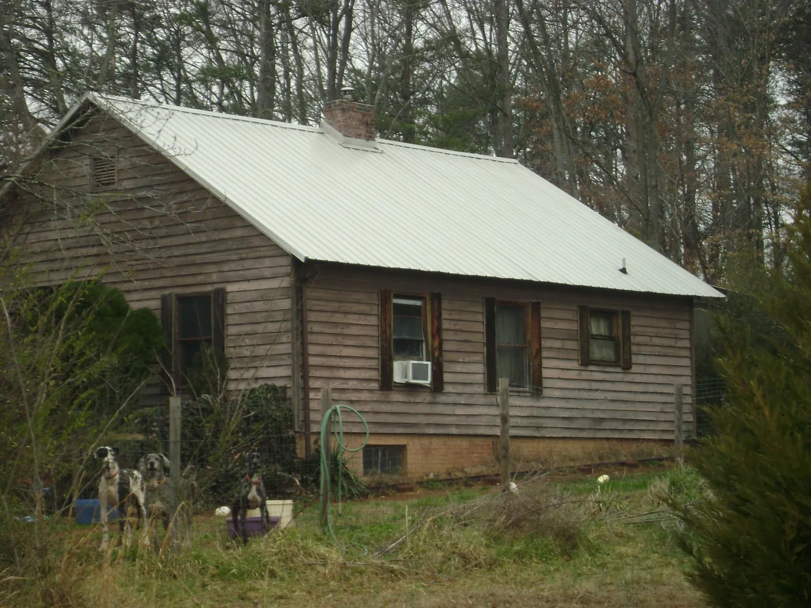 White metal roof on an old wood sided farmhouse, from a Asphalt Shingle Roof Repair job in Ravenel